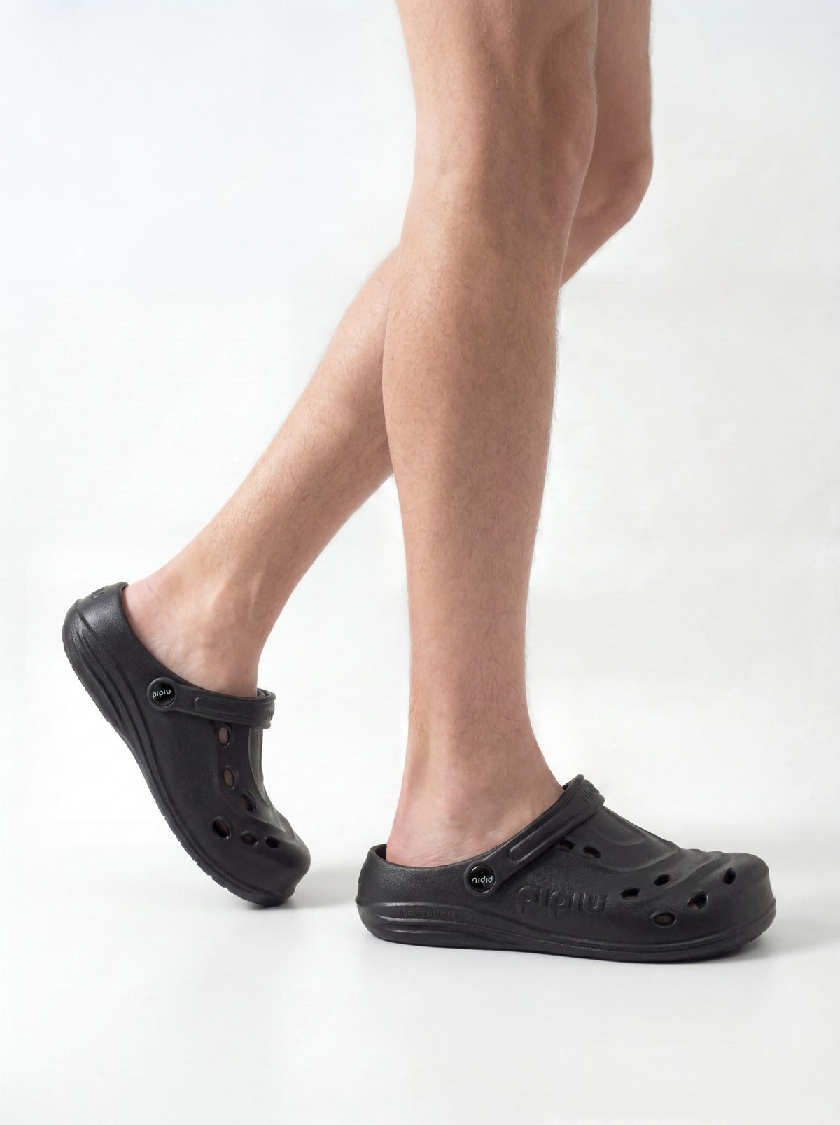Person walking in black pipiu clogs