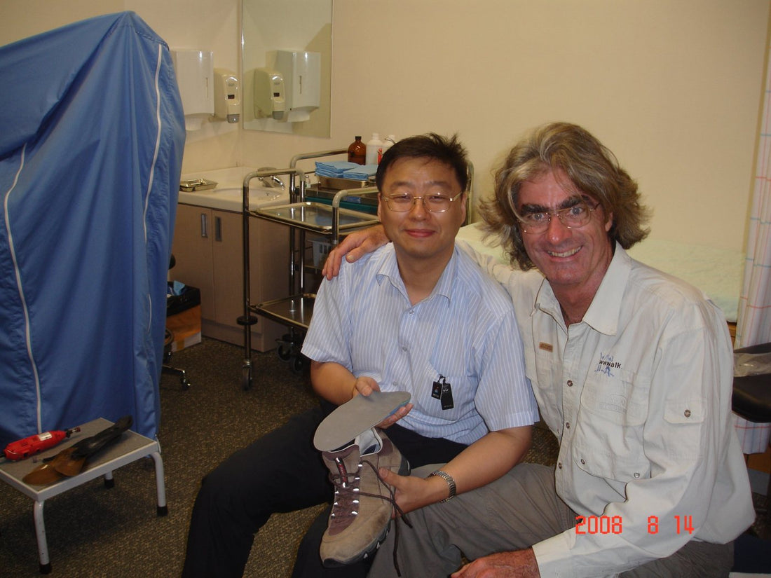 Dr. Dongyeop Kim holding a custom insole beside Jean Béliveau, August 2008