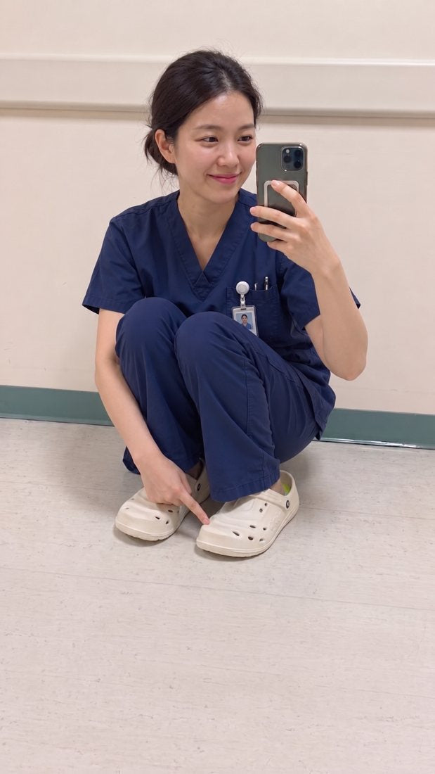 Nurse wearing ivory pipiu clogs in a hospital hallway